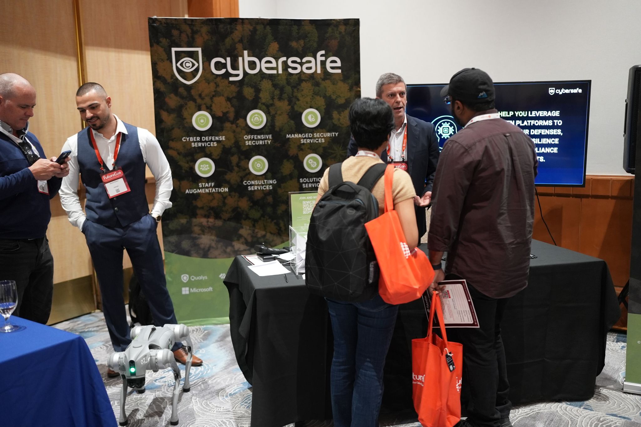 Dinis Fernandes speaking with attendees at the CyberSafe booth at FutureCon Vancouver 2026