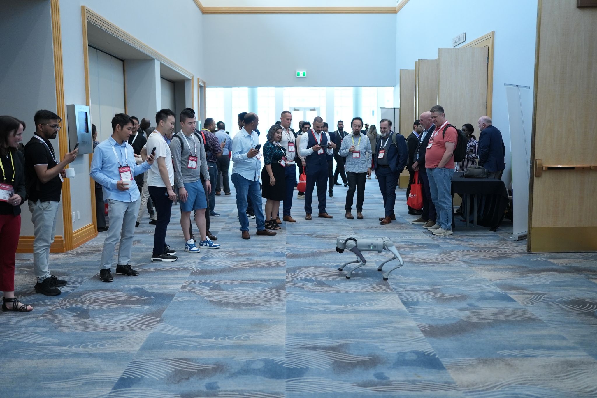 A robot dog roams the conference floor at FutureCon Vancouver 2026 as attendees look on